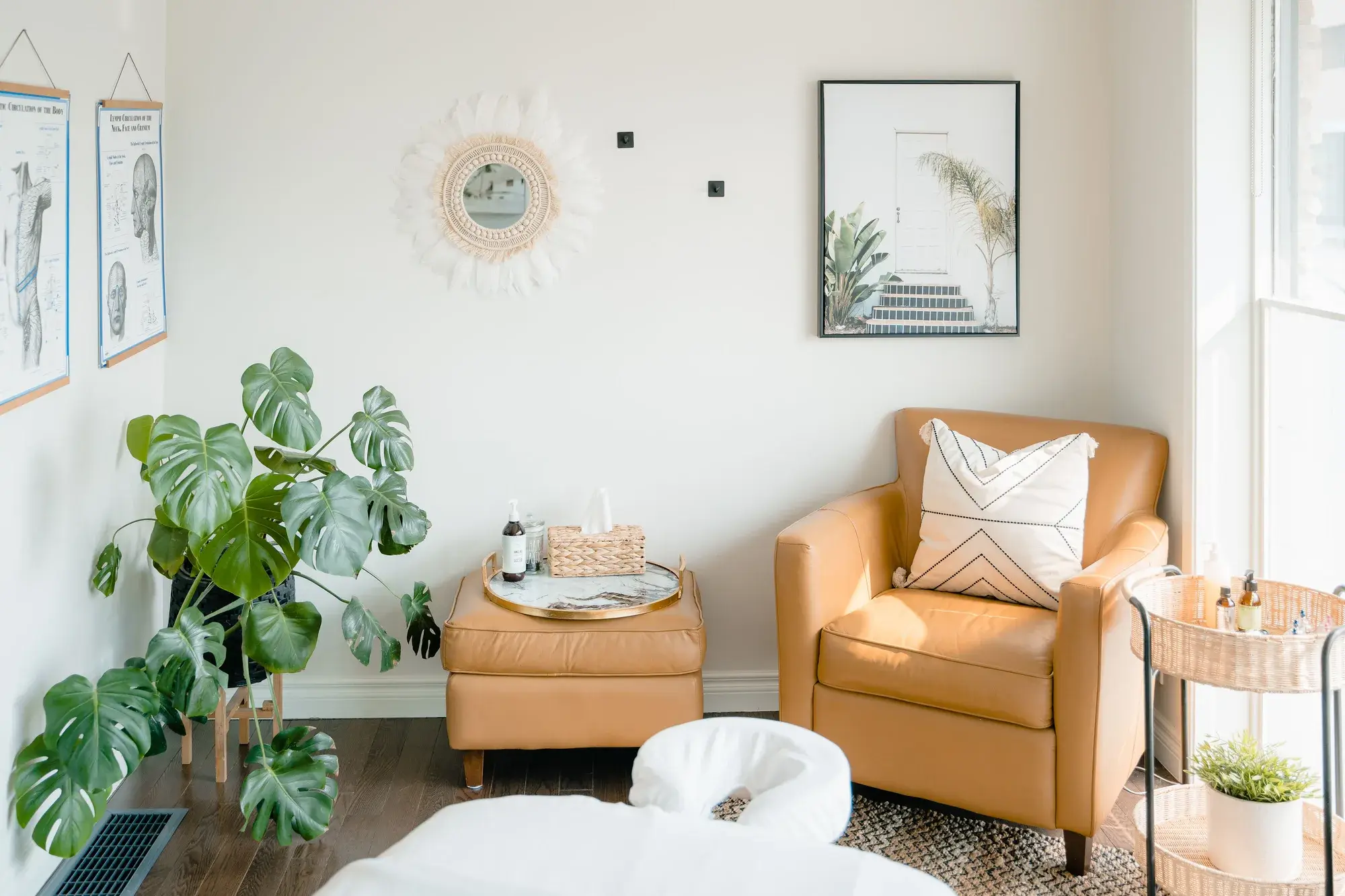The lounge at Renu with leather armchairs and plants