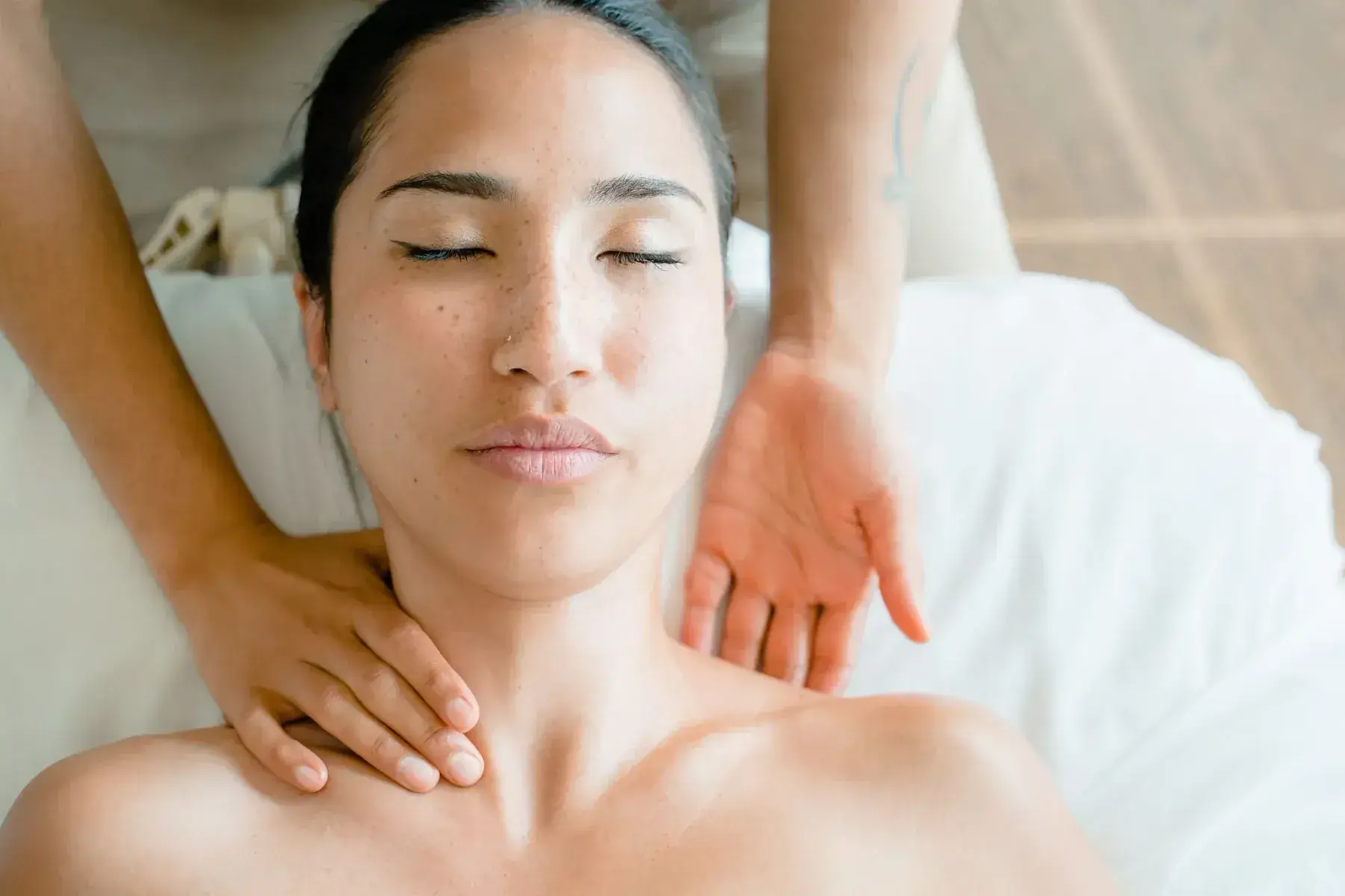 Gentle lymphatic strokes along the jaw and neck during a lymphatic facial