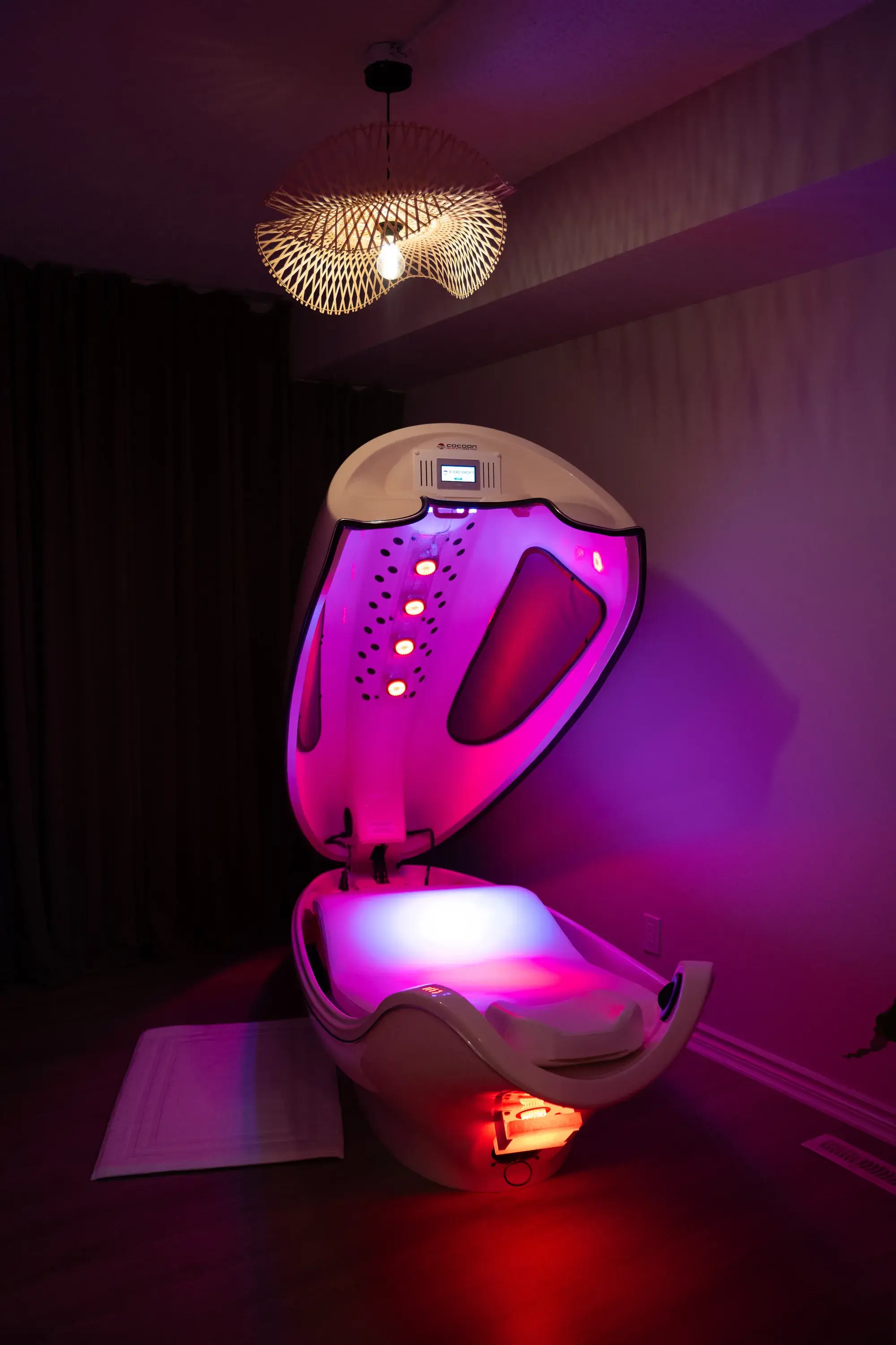 The infrared cocoon wellness pod glowing in its private room at BodyTox by Renu